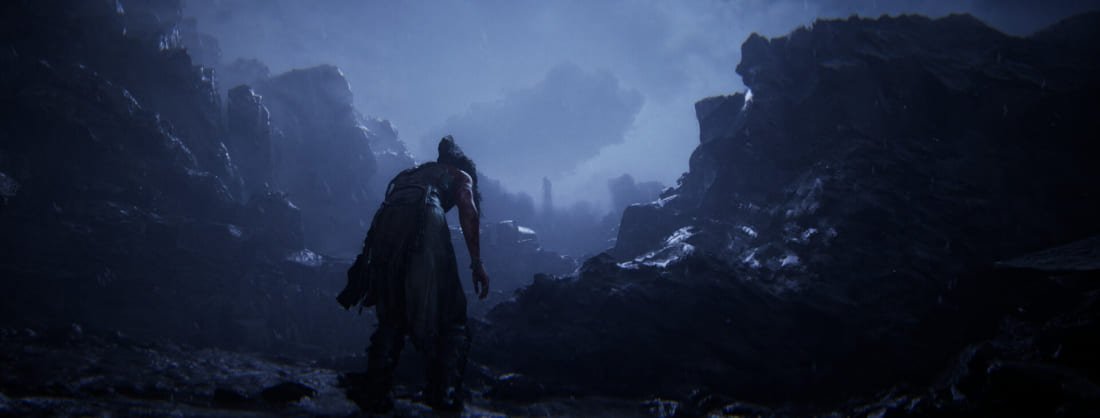 Lone warrior walking through dark, rocky terrain in Hellblade 2 video game